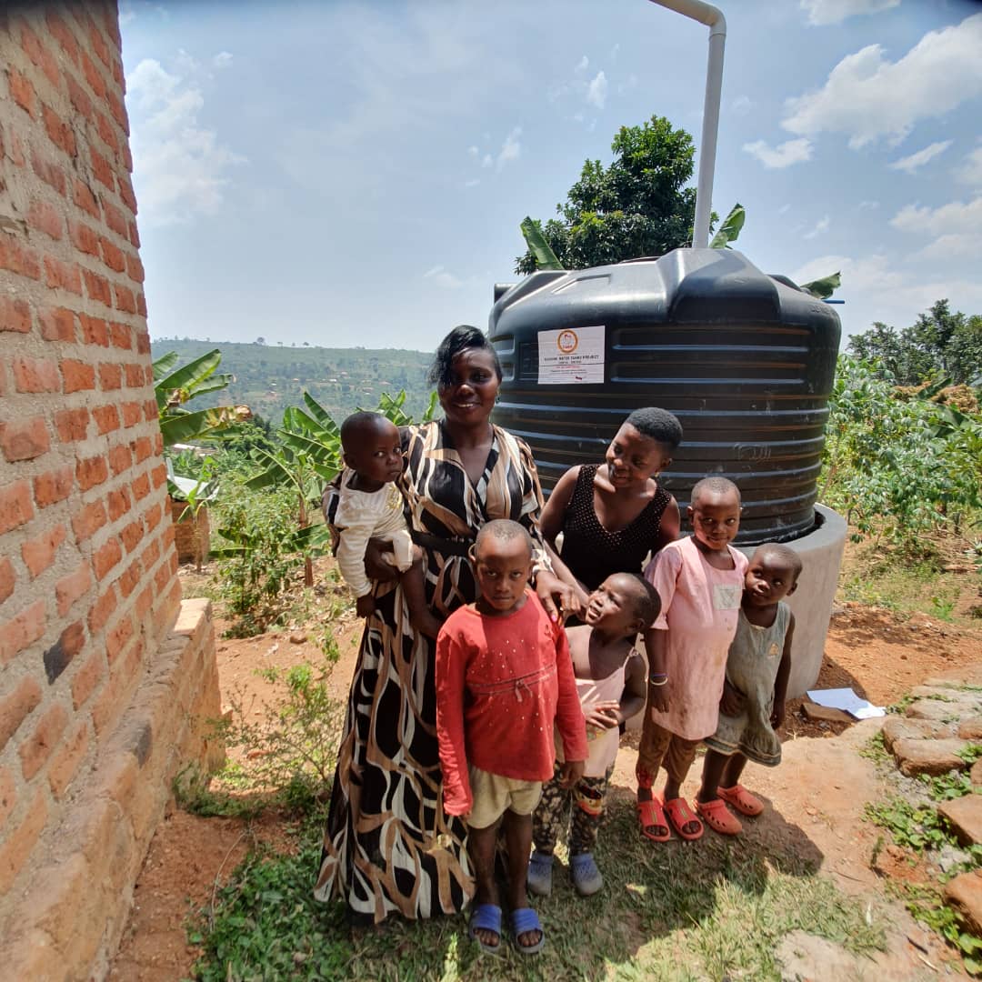 Family receiving a water tank through MRF WASH program