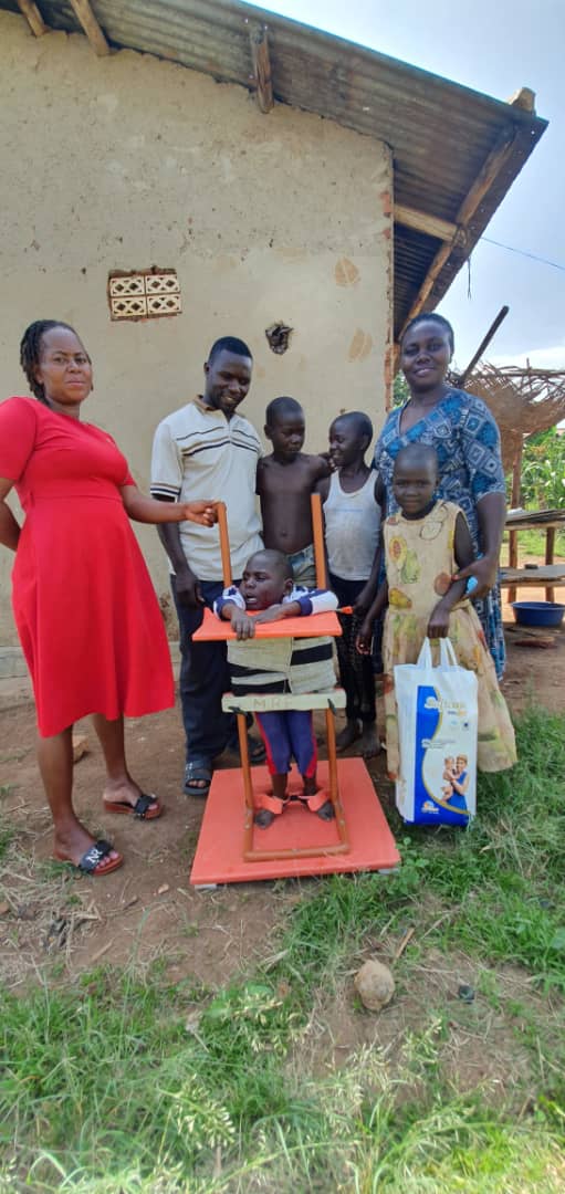 Jovan receiving a standing frame from MRF for mobility support